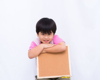 Portrait of smiling girl against white background