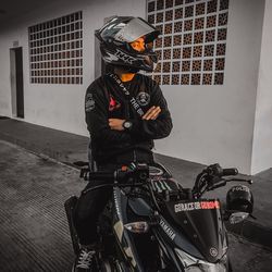 Man riding motorcycle on street in city