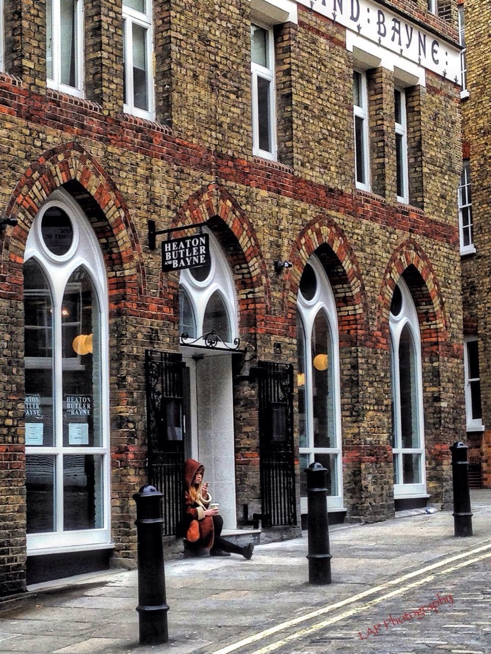 building exterior, architecture, built structure, window, arch, city, street, building, facade, door, entrance, cobblestone, day, brick wall, outdoors, sidewalk, residential building, pavement, residential structure, brick