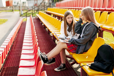 Happy schoolgirls do homework together in the school stands after school. the concept of training