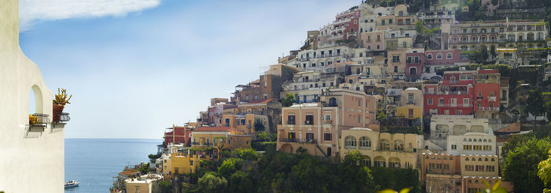 Panoramic shot of townscape by sea against sky