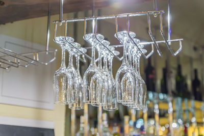 Hanging glassware. empty clean glass for vine and champagne at the bar. selective focus