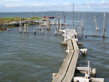 Wooden posts on pier over sea