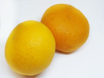 Close-up of oranges against white background