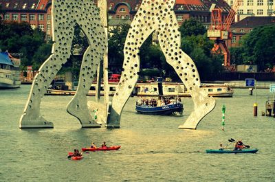 Boats in river with buildings in background