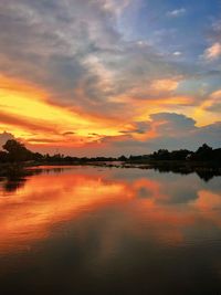 Scenic view of lake against romantic sky at sunset