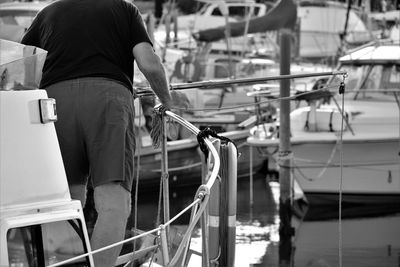 Midsection of man on boat in sea