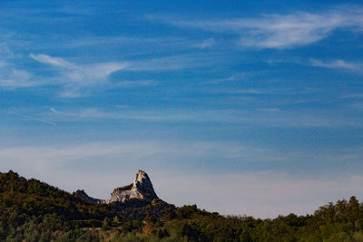 Scenic view of mountains against blue sky