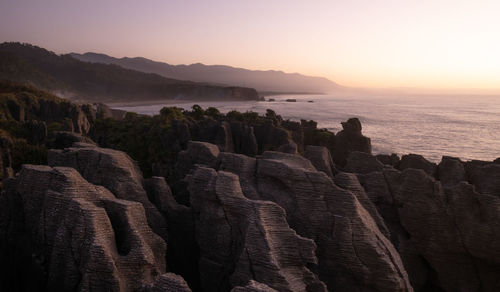 Unusual rock formations,oceans coast during sunset.punakaiki pancake rocks, west coast, new zealand