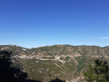 Scenic view of mountains against clear blue sky