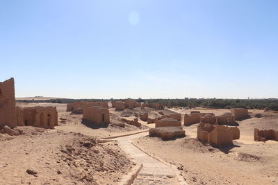 Scenic view of desert against clear blue sky