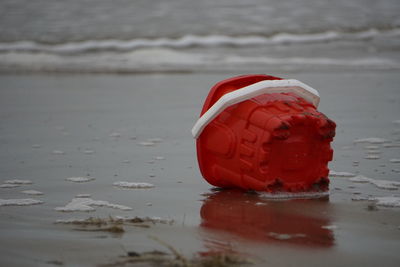 Close-up of red ball on beach