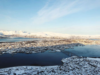 Scenic view of frozen lake against sky during winter