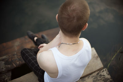 Rear view of woman sitting outdoors