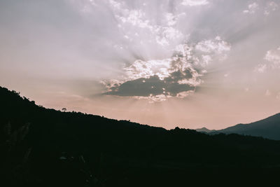 Scenic view of silhouette mountains against sky at sunset