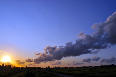 Panoramic view of field against sky during sunset