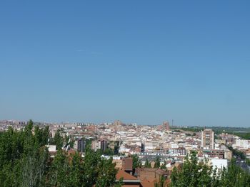 Buildings in town against blue sky