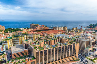 High angle view of buildings by sea against sky