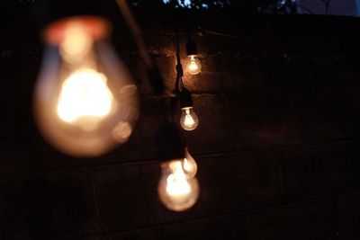 Close-up of lit candle in dark room