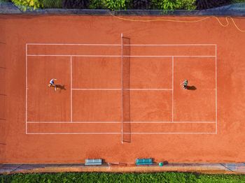 Directly above shot of athletes playing tennis at court