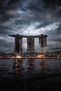 View of bridge over sea against cloudy sky