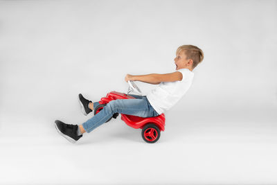 Side view of boy wearing hat against white background