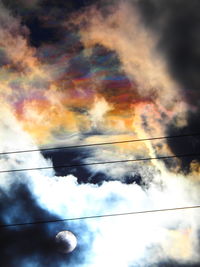 Low angle view of silhouette cables against dramatic sky