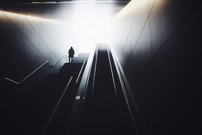 Low angle view of man walking on escalator