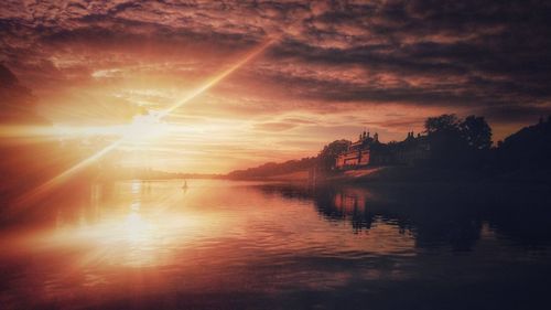 Scenic view of sunset over silhouette water