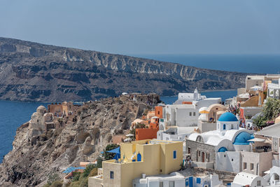 High angle view of buildings by sea against sky