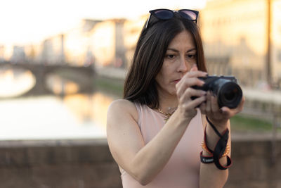 Portrait of photographer woman unfocused background at florence, italy. 50mm lens