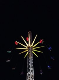 Low angle view of illuminated ferris wheel at night