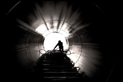 Silhouette people in tunnel