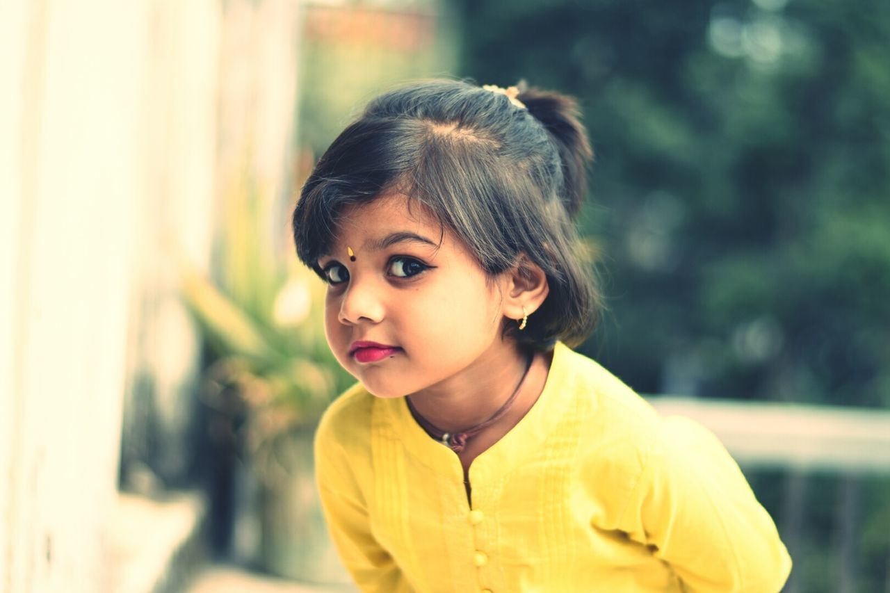 childhood, real people, focus on foreground, innocence, one person, elementary age, day, looking at camera, headshot, portrait, standing, outdoors, close-up