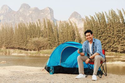 Portrait of young man sitting on land