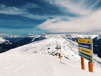 Text on snow covered mountain against sky