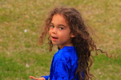 Side view portrait of cute girl at field