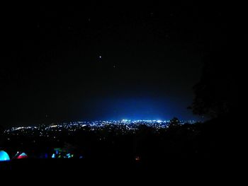 Illuminated fireworks against sky at night