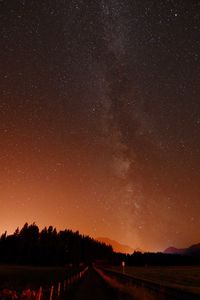 Road against star field at night