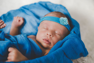 Cute baby sleeping in crib at home