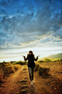 Full length of man standing on field against sky