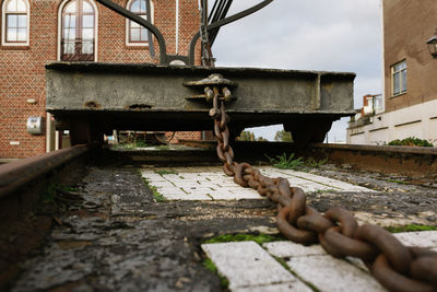 Close-up of rusty metal structure against sky