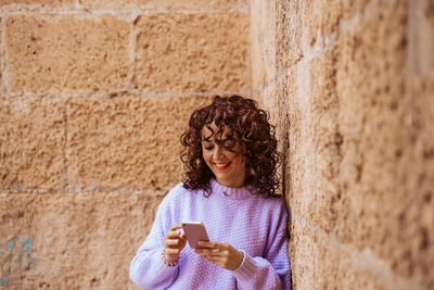 Portrait of young woman using mobile phone