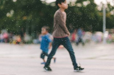 Full length of woman with arms raised in city