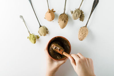 Cropped hand of woman holding food on table