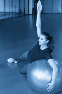 Rear view of woman exercising in gym