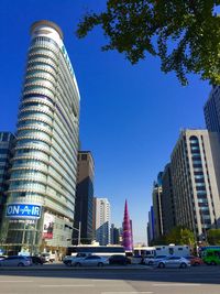 Low angle view of modern building against blue sky