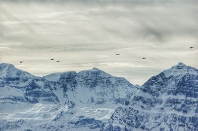 Scenic view of snow covered mountains against sky