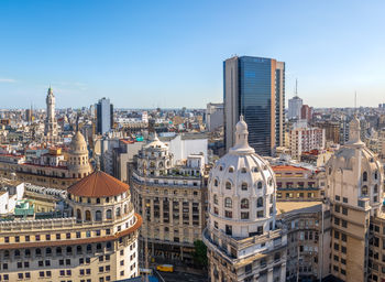 Buildings in city against clear sky