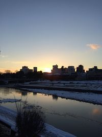 View of snow covered landscape at sunset